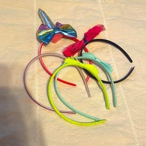 5 children head bands. Plain, with bows and one with unicorn horn